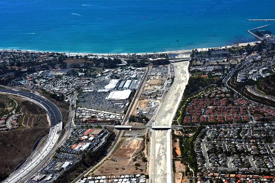 Aerial view of the coastline at Capistrano Beach CA showing Pacific Coast Highway, the rail corridor and tile roofed housing