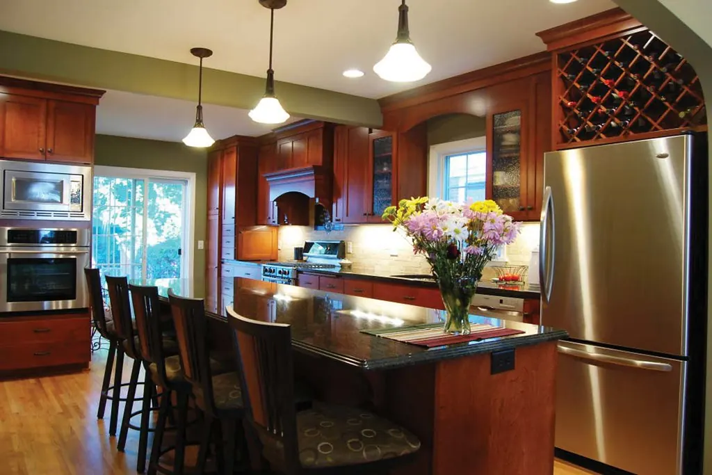 A dark cherry kitchen with an arched valance and a wine lattice, typical of 1990s hillside construction in San Clemente CA