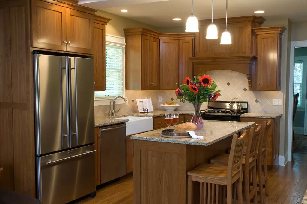 A stained wood custom kitchen with a granite island and an apron sink in a Southern California home of the kind found in San Clemente CA