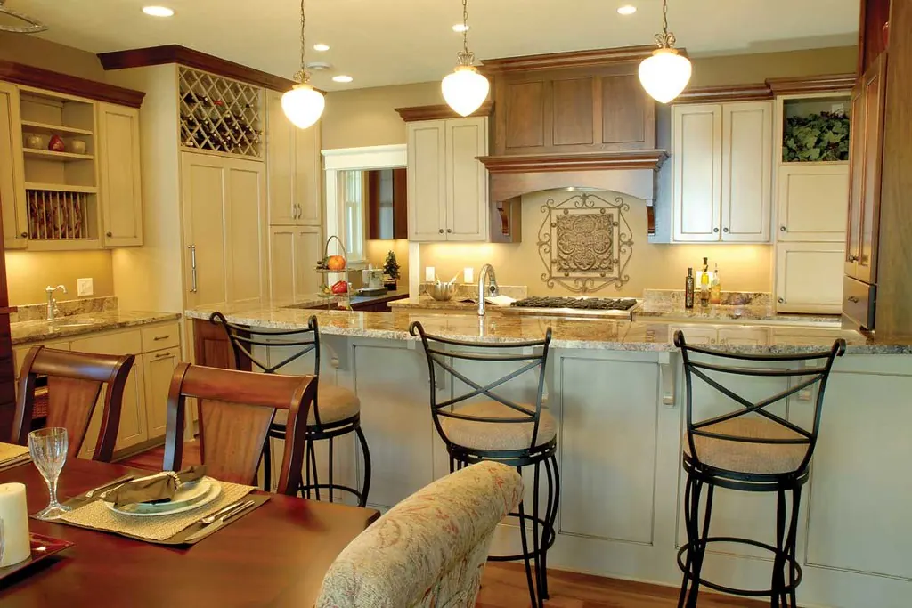 Cream painted perimeter cabinets and a stained wood island in a kitchen of the kind common in San Clemente CA