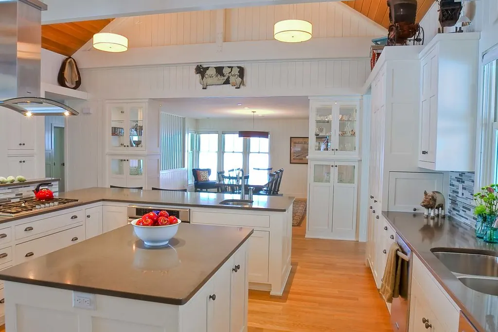 A white painted shaker kitchen with a light island in a coastal Southern California home near San Clemente CA